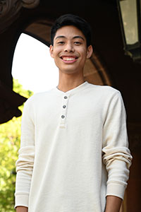 Matthew Louis Inkim standing under an archway.