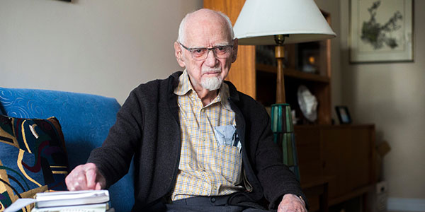 Rev. Gordon Toombs at the age of 101 seated on a blue couch. Rev. Gordon Toombs at the age of 101 seated on a blue couch.