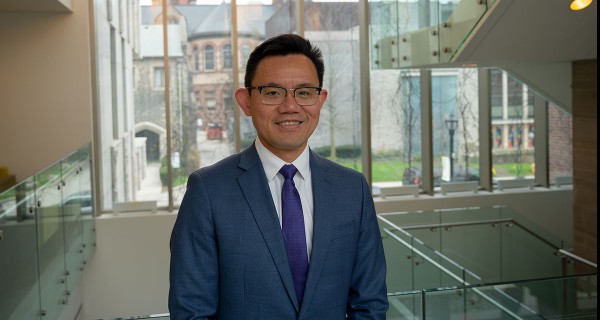 Ken Chan standing in the stairwell on a building on Victoria College campus.